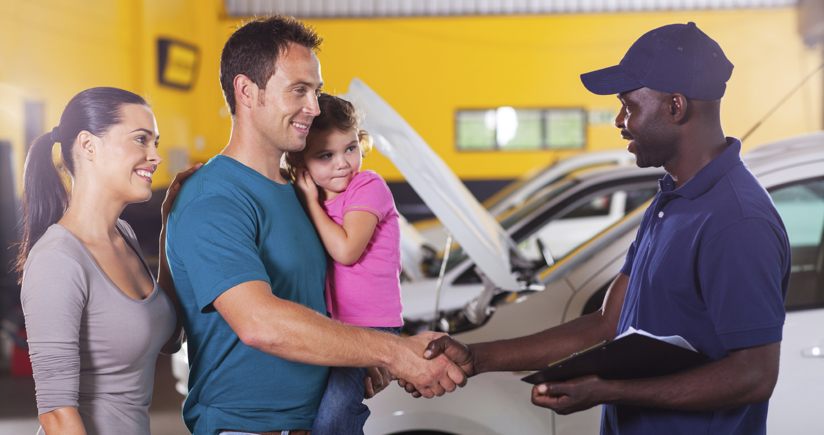 friendly mechanic handshaking with family