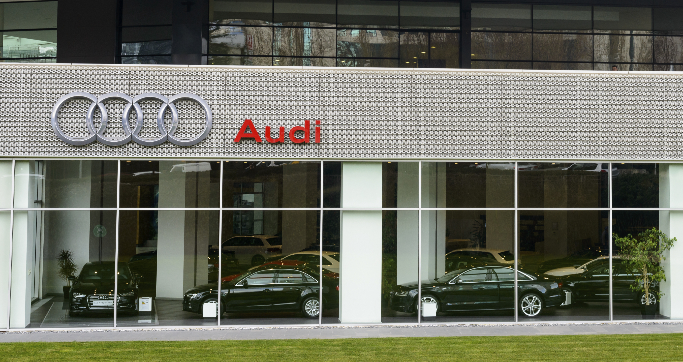 Audi luxury car dealership with various Audi models inside